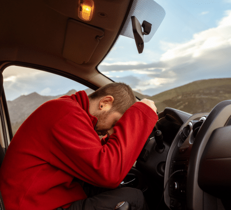 a truck driver sleeping on the wheel